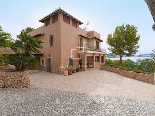 Unique first-row seafront villa with direct access to the beach and a boat dock in Cala Fornells, Calviá, South-West of Mallorca.